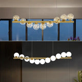 lustre nordique longue boule de verre or pour bar