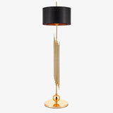 Lampadaire design doré avec abat-jour noir arrondi body